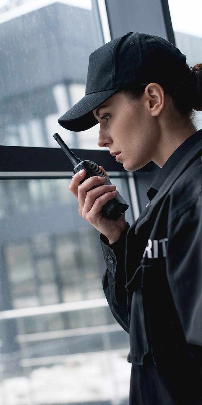 handsome-guard-in-black-uniform-talking-on-walkie